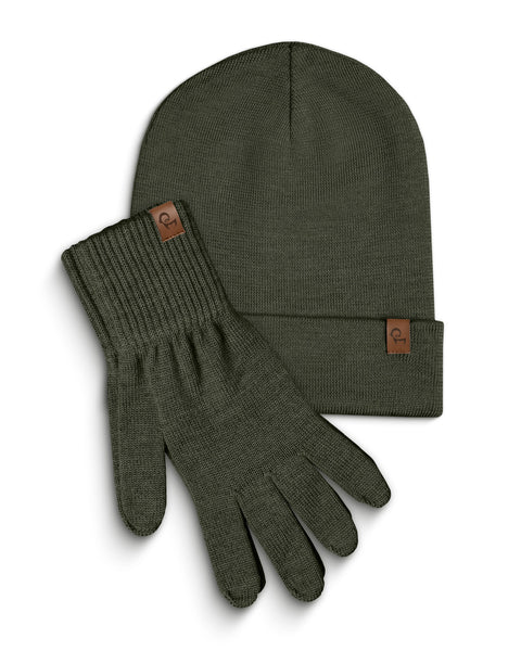 A dark green knitted beanie and a pair of matching gloves are laid flat against a white background. Both the beanie and each glove have a small, rectangular brown leather tag with a menique logo on them. The items are slightly overlapping, with the beanie positioned above and to the left of the gloves.