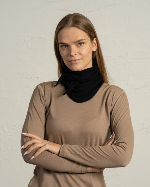 Woman wearing black Merino wool bandana styled as warm neck gaiter.