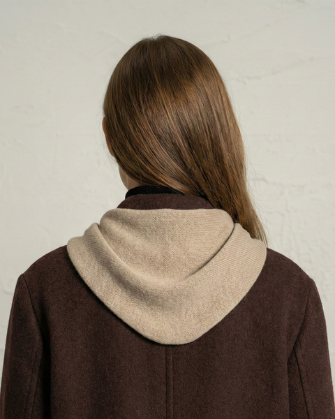 Back view of woman wearing creamy beige cashmere Merino knit bandana scarf.