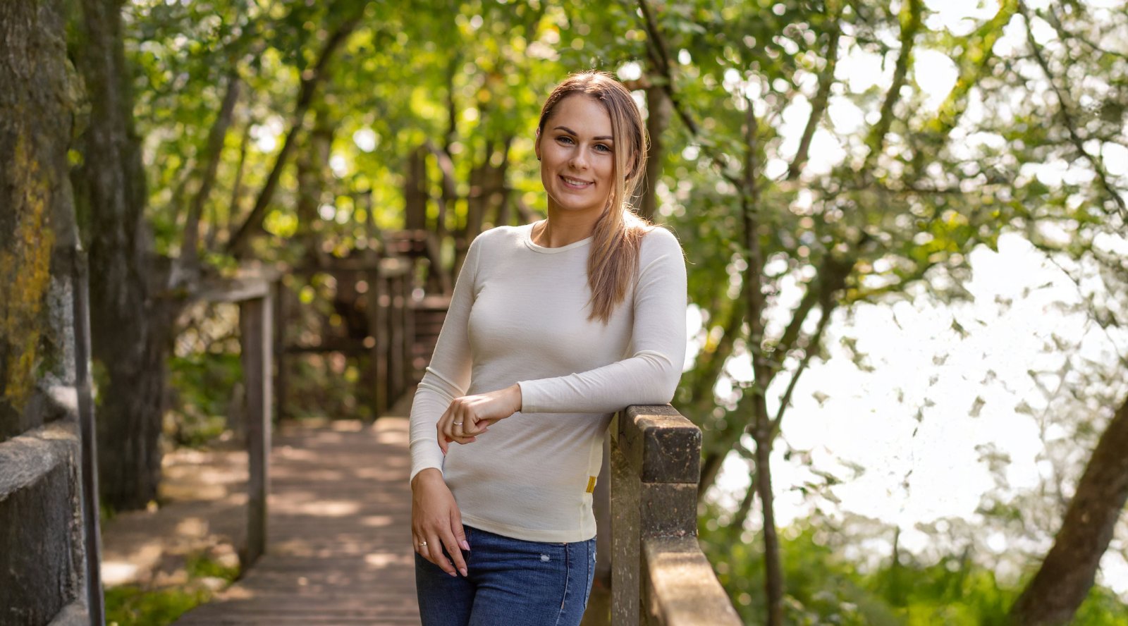 Woman sitting outdoors and wearing red leggings and black long sleeve top