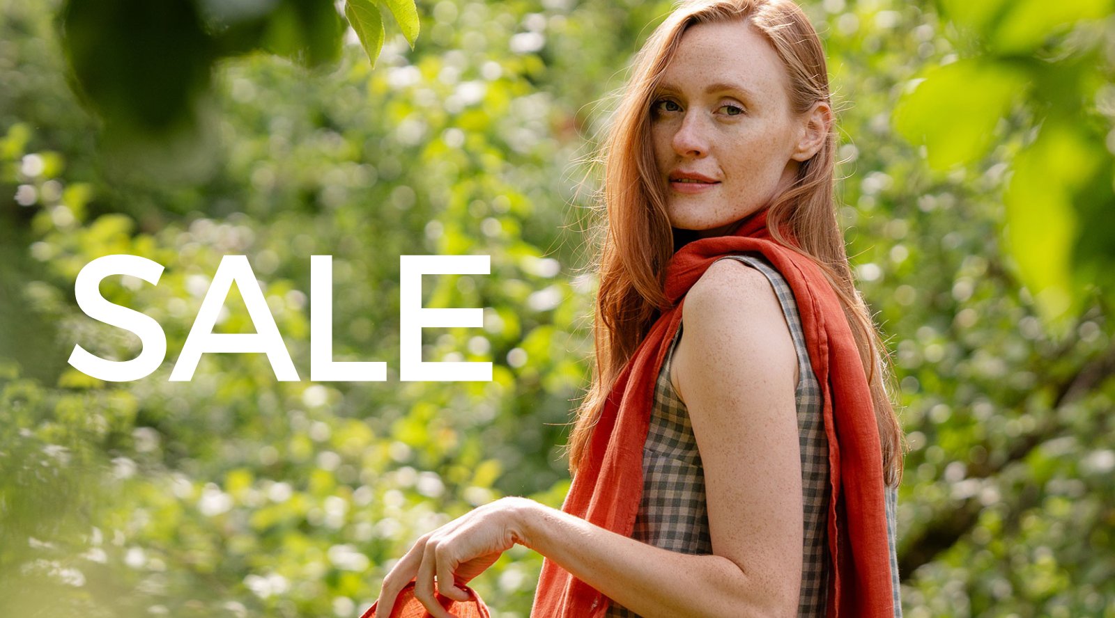 Made from Merino wool, menique clothes are hanging on a rack for sale.  