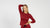 A woman wearing the menique merino wool long sleeve shirt in royal cherry, color, with one hand on her waist and the other above her head.