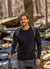 Man with a backpack hiking through a forest