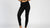 Person wearing black leggings on a white background