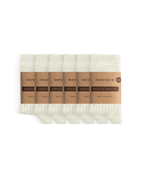 Set of six pairs of natural off-white ribbed thin socks for children, bundled together with Menique brown paper wraps marked ‘Premium Quality.