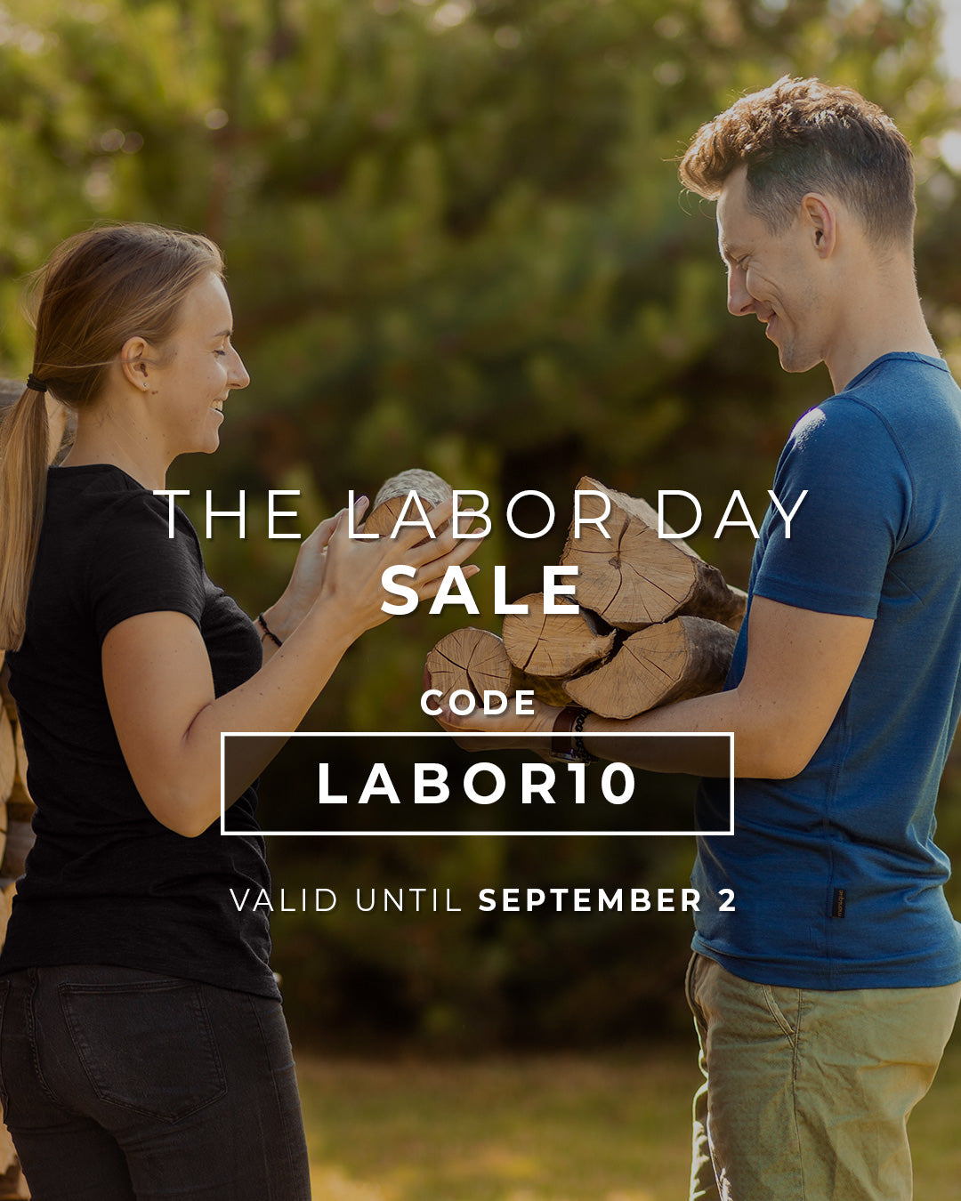 Two people holding wood with Labor Day sale text overlay