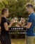 Two people holding wood with Labor Day sale text overlay