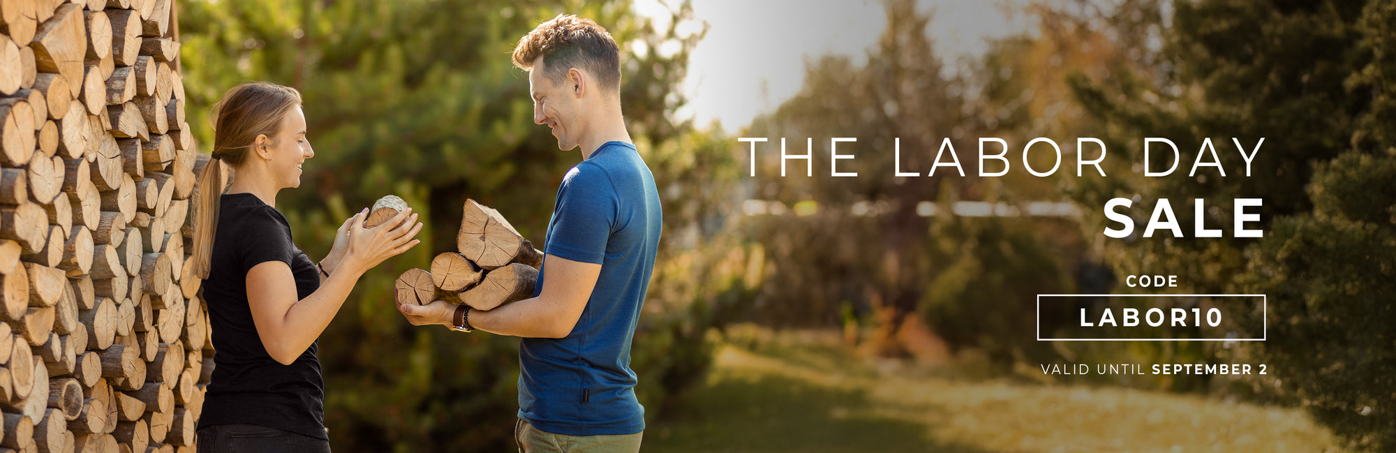Two people standing outdoors with a Labor Day sale banner overlay.
