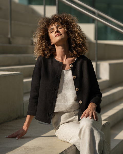 Woman with curly hair wearing natural linen jacket Alice