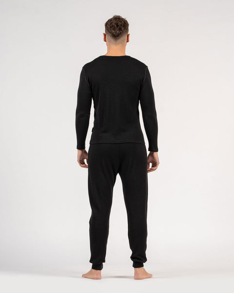The menique men&#39;s merino wool 250gsm long sleeve top and jogger sweatpants set in black color.