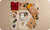 Collection of clothing and accessories on a beige surface with 'MENIQ' branding.