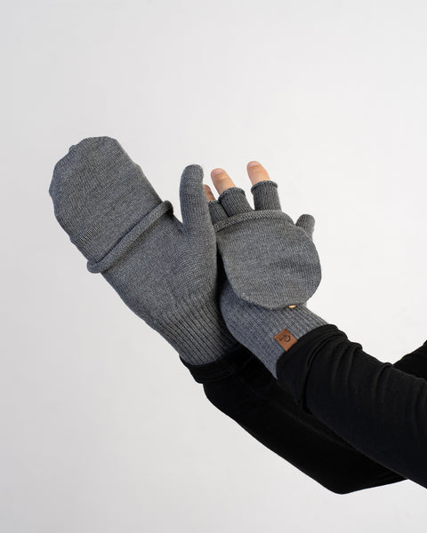 Dark gray merino wool convertible gloves with mitten flap, one open and one closed, displayed on white background.