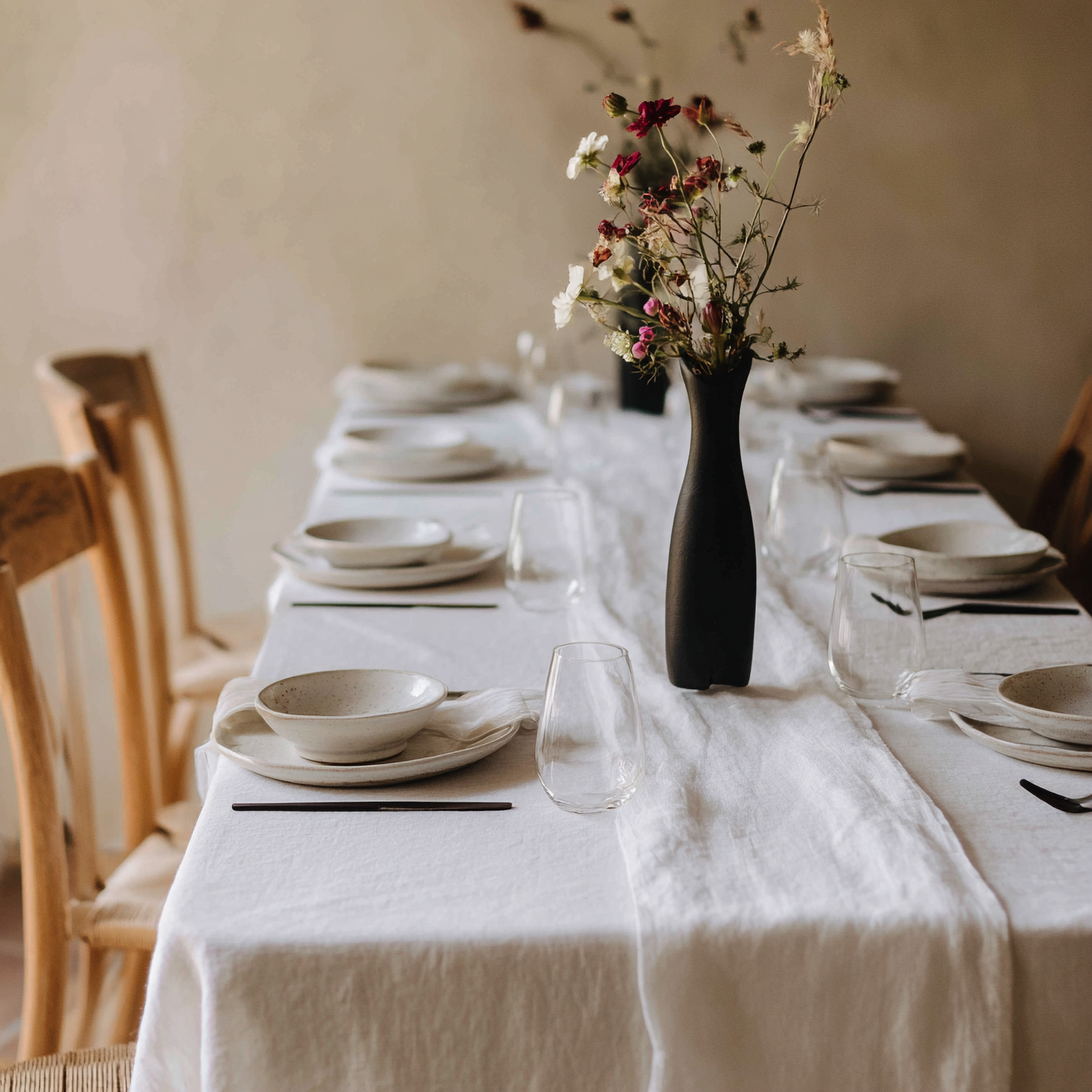 Vibrant yellow linen tablecloth with floral centerpiece for a warm, inviting dining room setup.