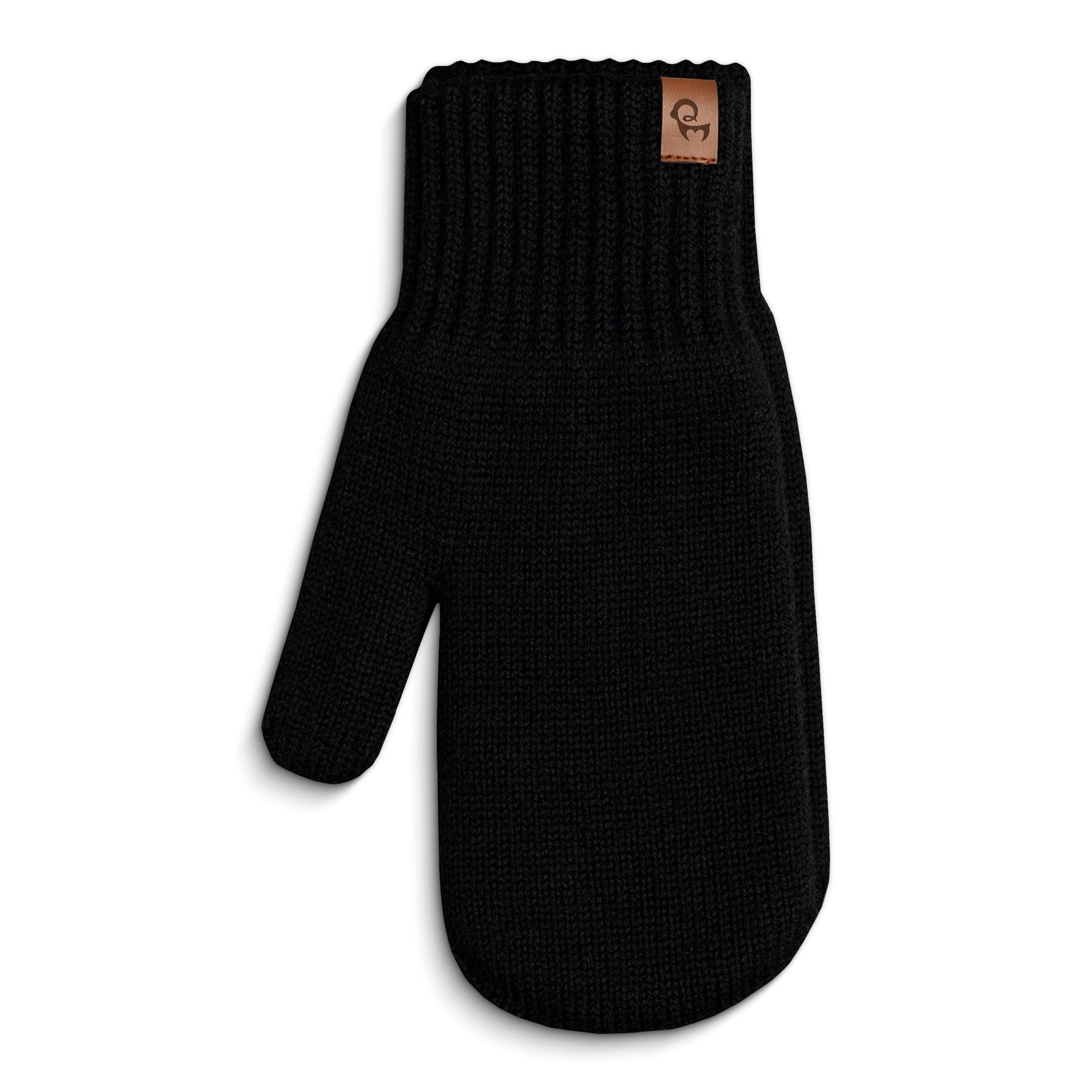 A person wearing a dark blue long-sleeved shirt and black menique mittens with a flap that can cover the fingers, turning them into mittens. The person is holding their hands together, and the flap on one glove is pulled back, exposing the fingers, while the flap on the other glove covers the fingers.