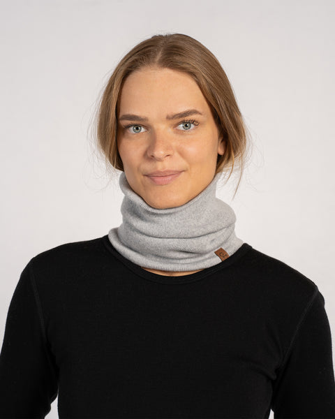 Unisex Merino Neck Gaiter in Light Gray, worn around the neck, styled with a black top.