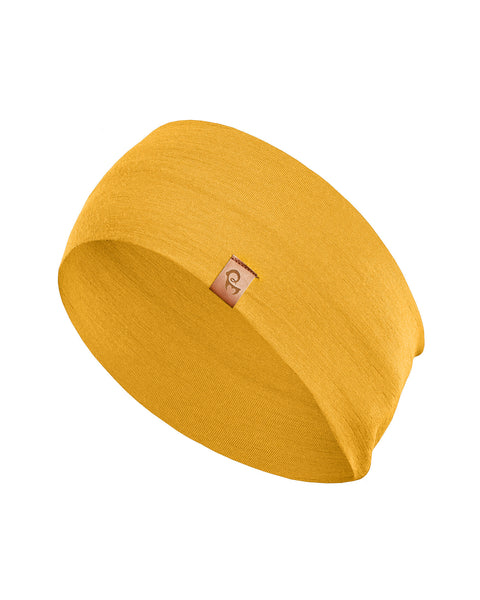 A spicy yellow menique headband is displayed on a white background. The headband has a slightly textured knit and features a small, light brown square tag sewn onto one side. The headband is angled slightly, showing its width and curved shape.