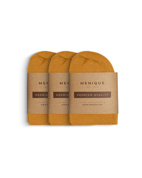 Three pairs of women’s bamboo socks in mustard yellow, folded side by side and packaged with Menique brown kraft labels marked ‘Premium Quality.