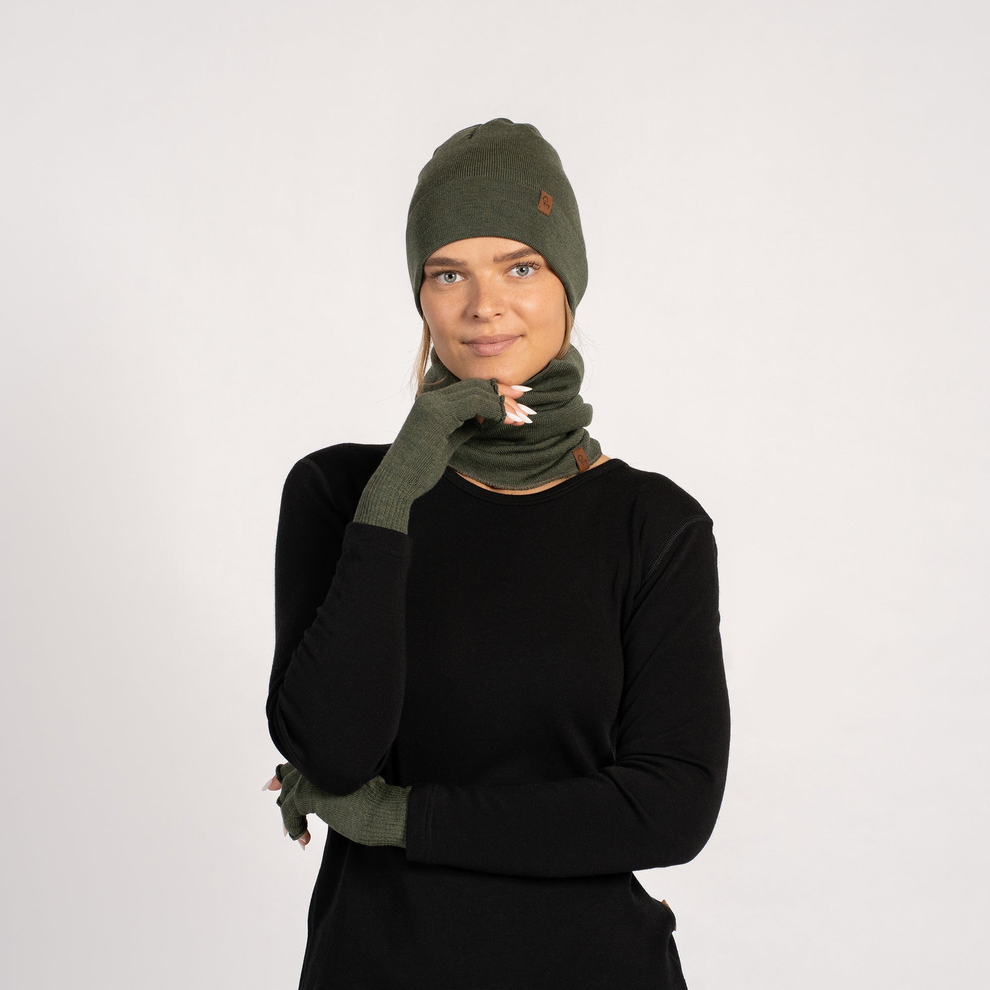 Dark Green menique knit beanie, neck gaiter, and fingerless gloves set on a white background