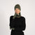 Dark Green menique knit beanie, neck gaiter, and fingerless gloves set on a white background