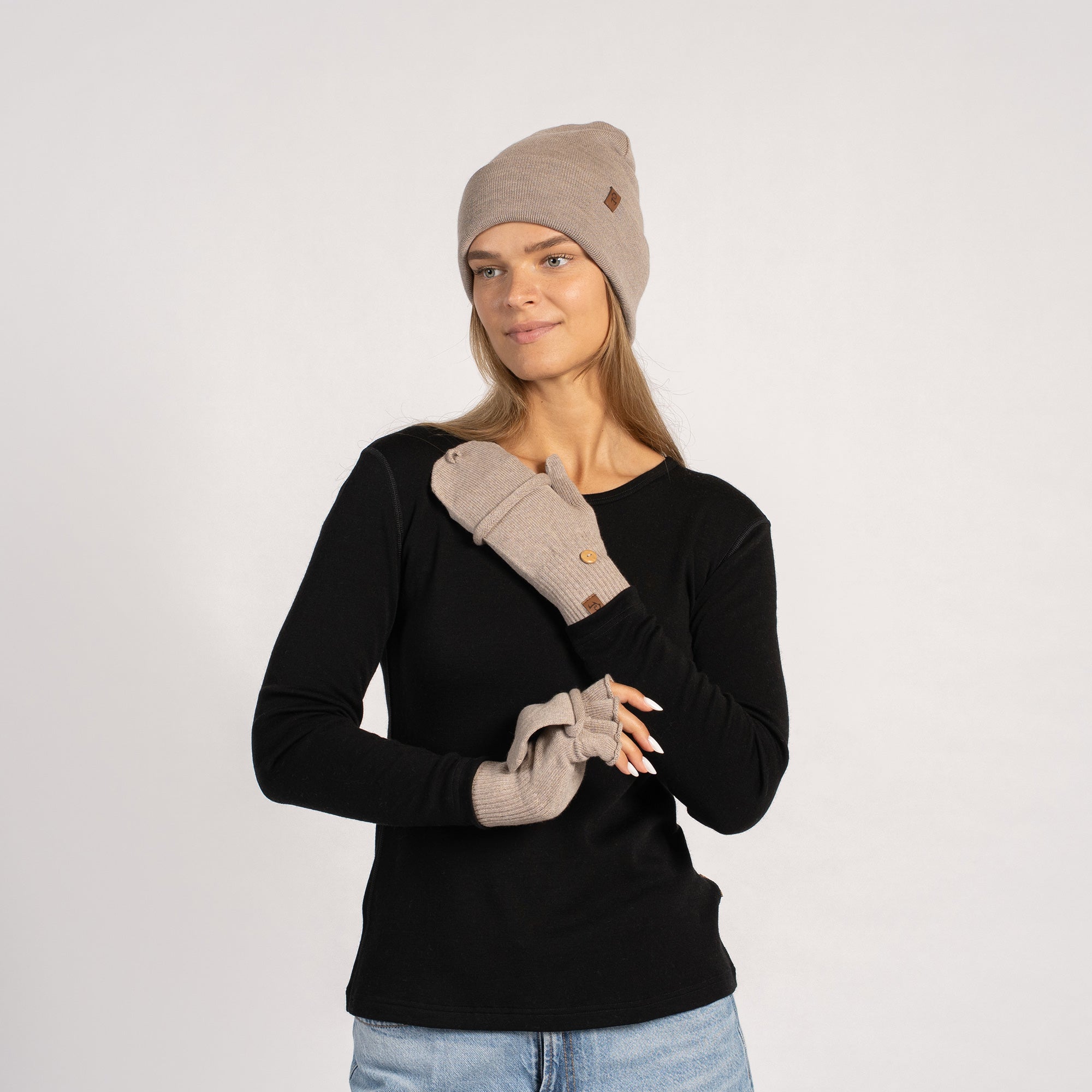 Women wearing knitted merino beanie and creamy beige convertible gloves, winter accessory set
