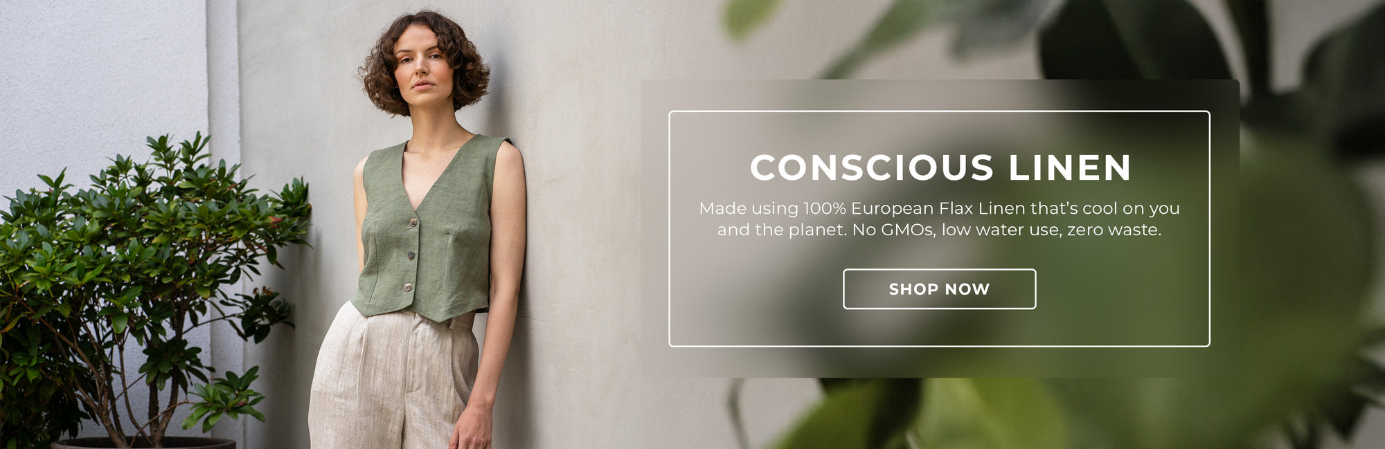 A person with short brown hair poses against a textured gray wall, wearing a green linen vest and cream-colored pants. To the right, a rectangular graphic panel displays the text "CONSCIOUS LINEN" and a description of the product, along with a "SHOP NOW" button. A green leafy plant is visible on the left side of the frame.

