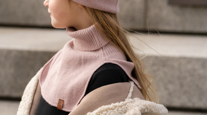 Girl standing outdoors and wearing dusty pink neck turtle dickie