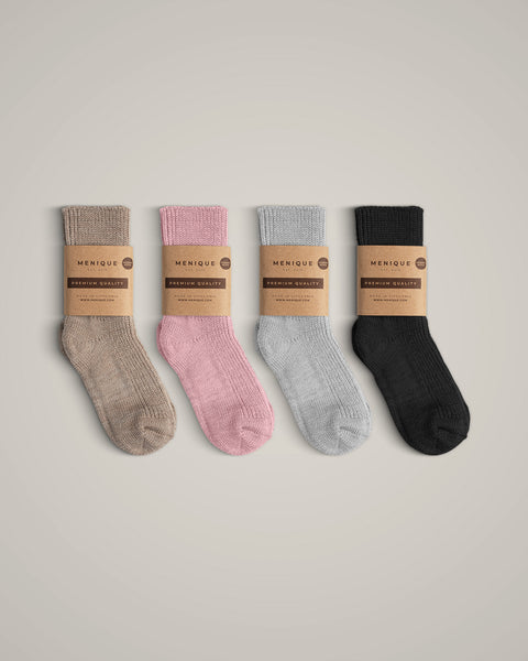 The menique kids&#39; merino wool thick ribbed socks in all available colors, with packaging.