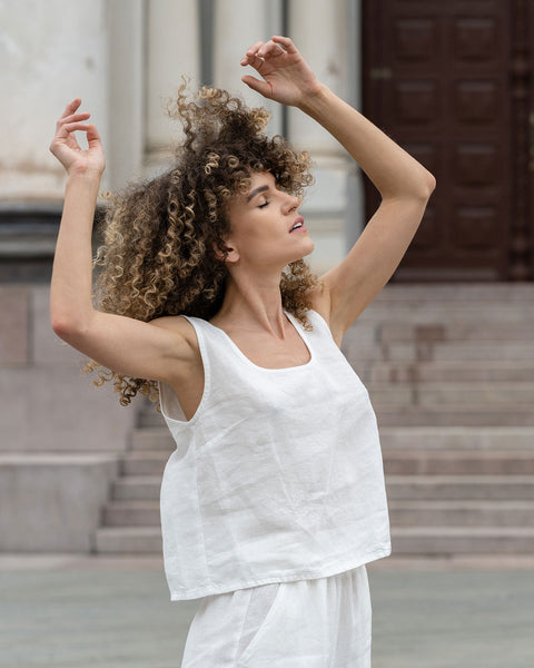 Woman standing outdoor and wearing Linen Sleeveless Crop Top Ana in Pure White color