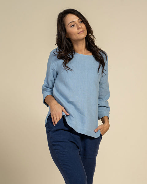Woman wearing linen blouse in cloudy blue color front 